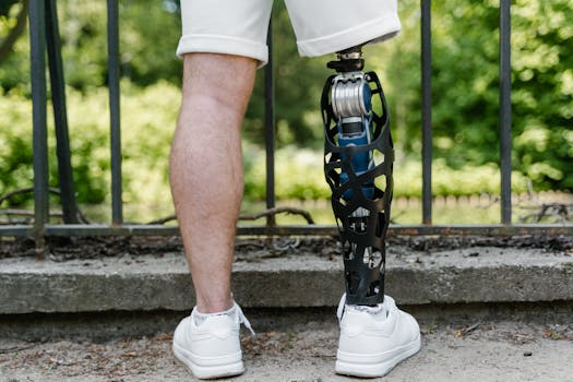 A person with a modern prosthetic leg standing outdoors on a sunny day.