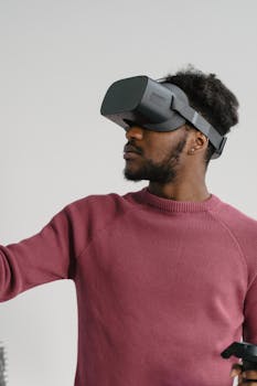 Young man immersed in virtual reality using a headset and controller in a modern setting.